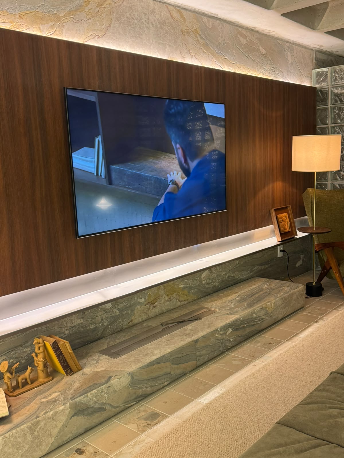 Lareira ecológica linear instalada em painel de madeira com TV