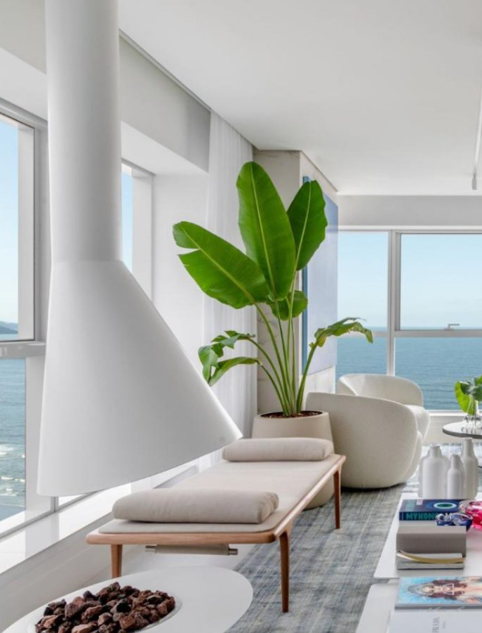 Lareira suspensa cone branca em apartamento com vista para o mar